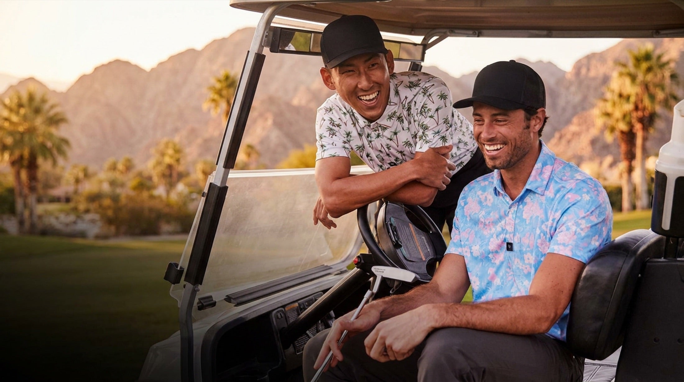 Golf buddies laughing in their cart at golden hour